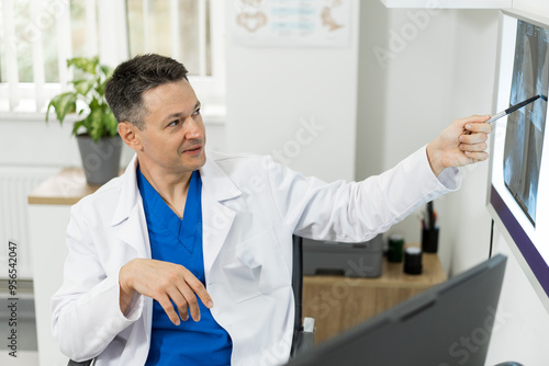 Doctor reviewing patient x-rays in a modern clinic setting. A healthcare professional analyzes x-ray images while explaining findings to a patient