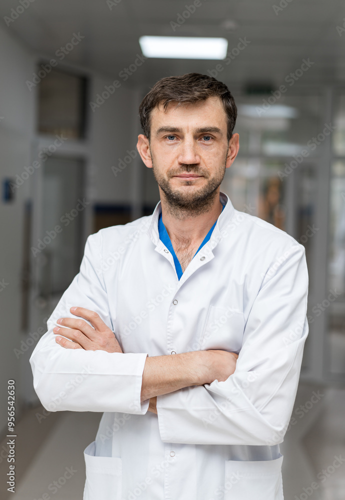 Confident healthcare worker in a white coat, hospital hallway. A healthcare professional stands with arms crossed in a hospital corridor Confident healthcare worker in a white coat, hospital hallway. A healthcare professional stands with arms crossed in a hospital corridor