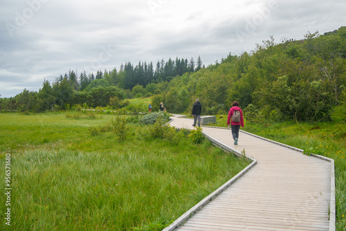 People walking on a wooden trail in pingvellir National Park, Iceland photo