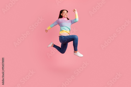 Full length body size view of nice attractive lovely glad cheerful wavy-haired girl jumping having fun rising hands up isolated on bright vivid shine vibrant color background