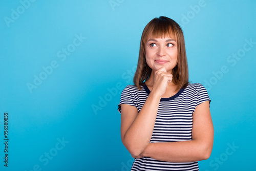 Portrait of minded woman touch hand chin think thoughts isolated over blue color background