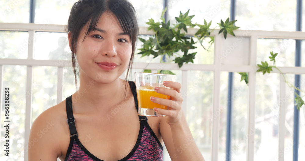 Women hands holding cold orange juice fresh fruit cool drinking. Asian women smile laugh look at camera health care home fitness lifestyle. Beautiful female pouring orange juice from cocktail bottle Women hands holding cold orange juice fresh fruit cool drinking. Asian women smile laugh look at camera health care home fitness lifestyle. Beautiful female pouring orange juice from cocktail bottle