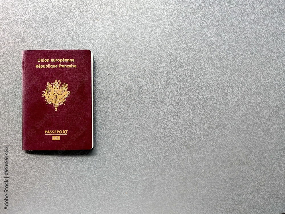 Photo of french passeport on the grey leather-like textured background. european biometric passport for the french republic. Copy space Photo of french passeport on the grey leather-like textured background. european biometric passport for the french republic. Copy space