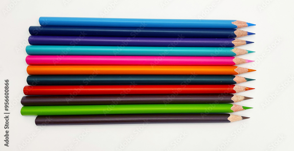 Colorful sharpened pencils are lined up on the table. Colorful sharpened pencils are lined up on the table.