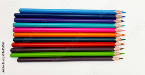 Colorful sharpened pencils are lined up on the table.