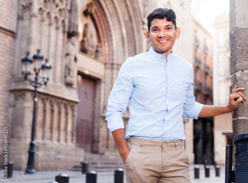 Smiling young guy on city street