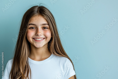 Youthful Determination and Joy: Gen Z Student Posing Casually Against a Neutral Blue Background