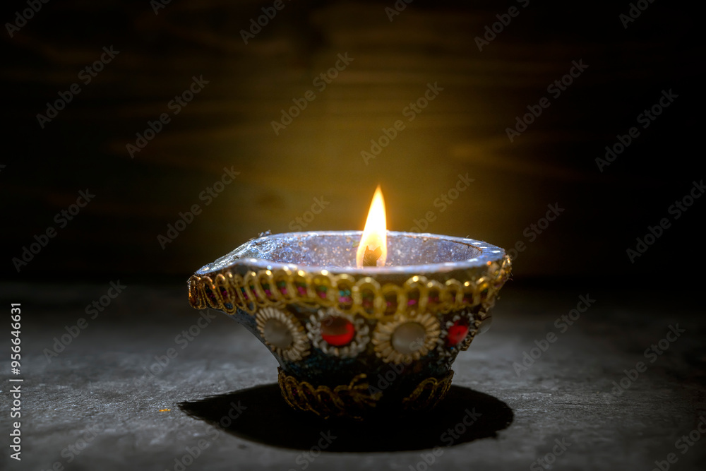 A blue and gold decorated pot with a blue and white design sits on a dark surface A blue and gold decorated pot with a blue and white design sits on a dark surface