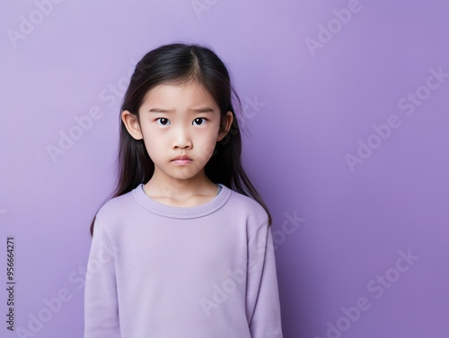 Lavender background sad Asian child Portrait of young beautiful in a bad mood child Isolated on Background, depression anxiety fear burn out health  photo