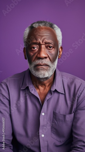 Lavender background sad black American independent powerful man. Portrait of older mid-aged person beautiful bad mood expression isolated 