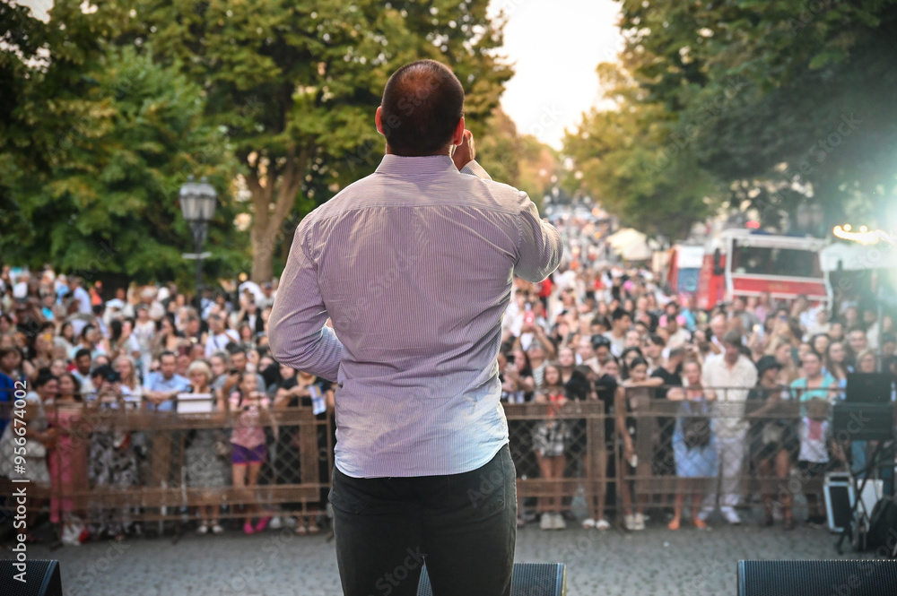 soloist sings on stage outdoors