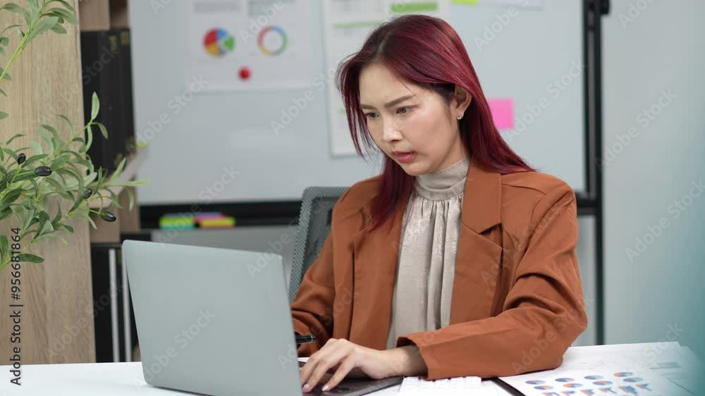 Asian businesswoman suffering headache working laptop Asian businesswoman suffering headache working laptop