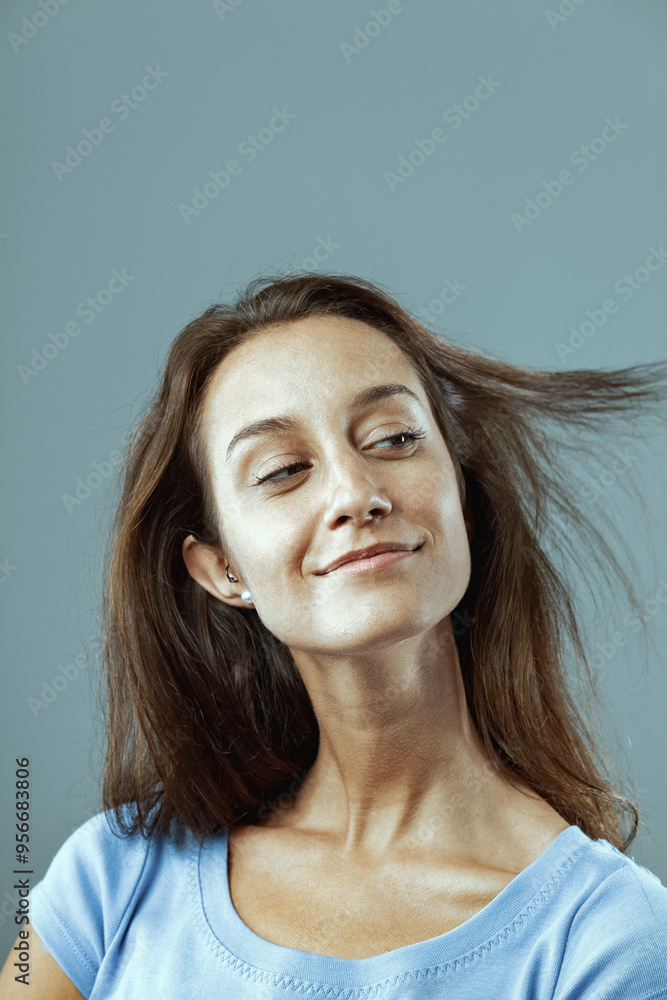 Young woman flipping hair smiling looking happy and carefree Young woman flipping hair smiling looking happy and carefree