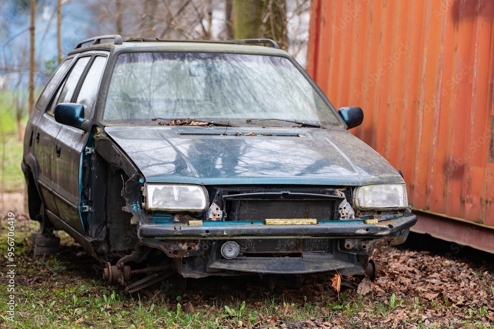 Wreck of blue Czech old estate car without wheels, bumper