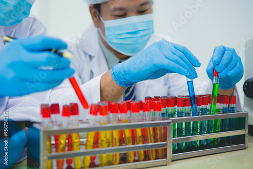 In this chemical experiment, two researchers collaborate to mix reactants, carefully observe changes such as color shifts or gas production, and analyze results, demonstrating principles of chemistry