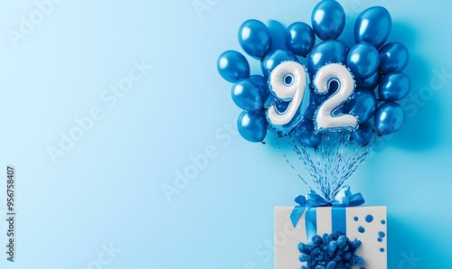 Happy birthday 92th with blue foil balloons and gift box on color background photo