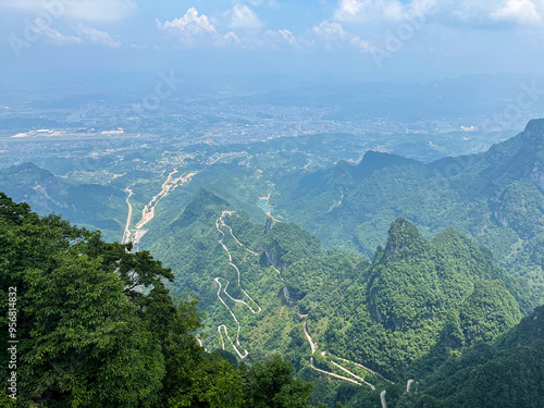 Aerial view of National Forest Park of Tianmen Mountian and city on background, Zhangjiajie, Hunan, China.