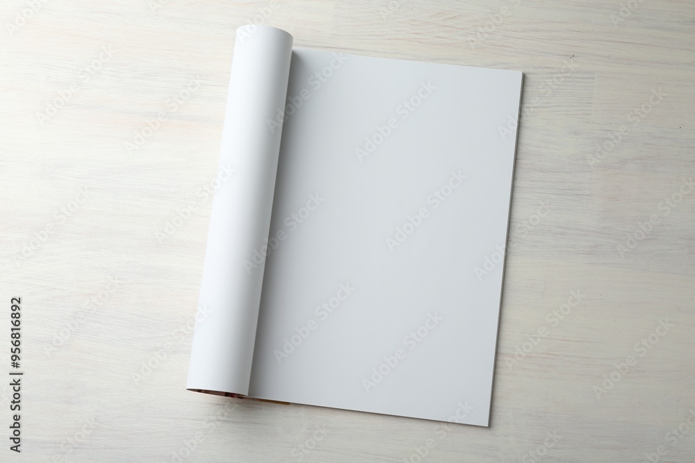 Open magazine with blank page on light wooden table, top view. Mockup for design Open magazine with blank page on light wooden table, top view. Mockup for design