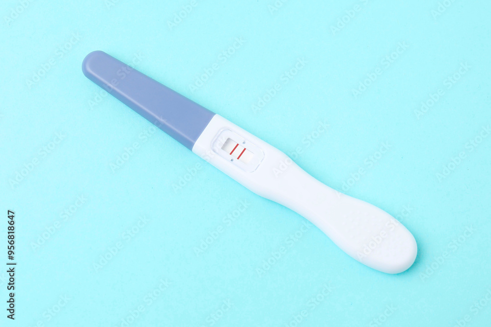 One pregnancy test on light blue background, closeup One pregnancy test on light blue background, closeup