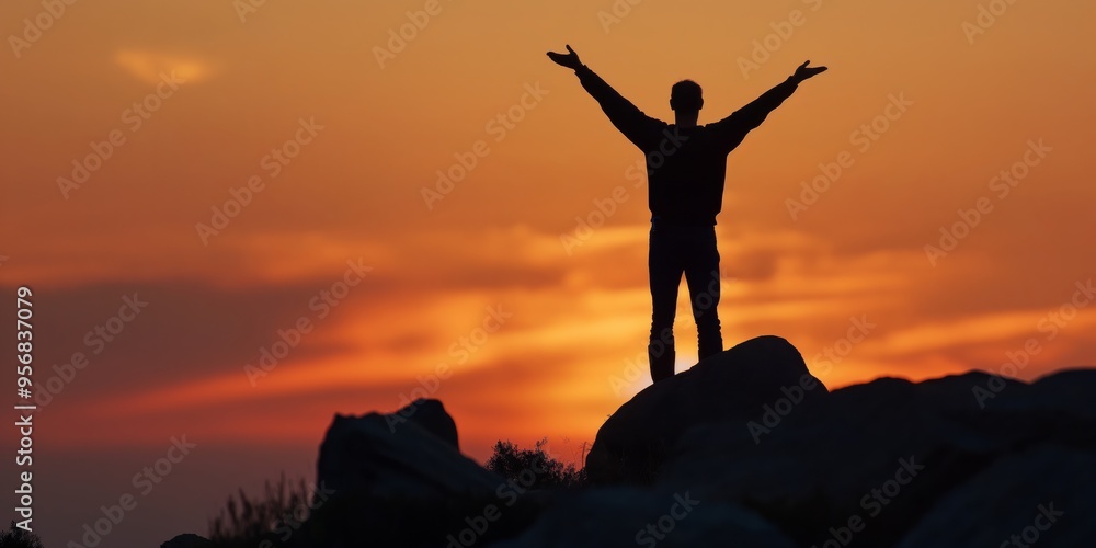Person standing on a mountain peak with their arms outstretched, silhouetted against a vibrant orange sunset, full of hope and achievement in nature's serenity. Person standing on a mountain peak with their arms outstretched, silhouetted against a vibrant orange sunset, full of hope and achievement in nature's serenity.
