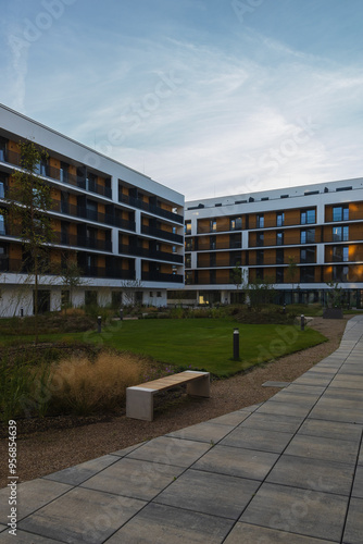 Modern living building with park, bench and trees. Downtown czech real estate, housing background