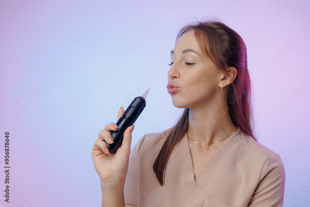 Portrait of young woman permanent makeup artist holding tattoo machine Portrait of young woman permanent makeup artist holding tattoo machine