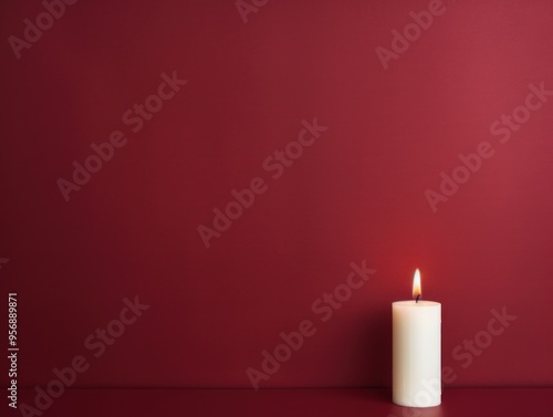 Maroon background with white thin wax candle with a small lit flame for funeral grief death dead sad emotion with copy space texture for display 