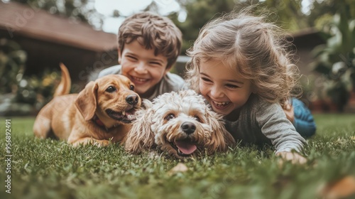 Two siblings playfully wrestle on the grass in their backyard, their dog joining in the fun, capturing a lighthearted and humorous moment of family life photo