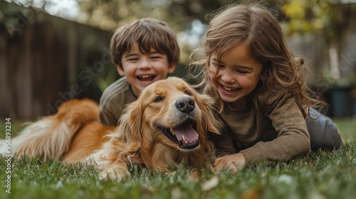 Two siblings playfully wrestle on the grass in their backyard, their dog joining in the fun, capturing a lighthearted and humorous moment of family life photo