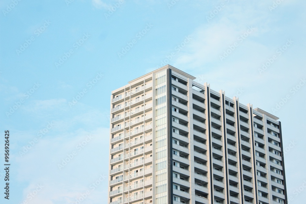 Modern High-Rise Apartment Building Against Clear Blue Sky, Hiroshima, Japan. With copy space Modern High-Rise Apartment Building Against Clear Blue Sky, Hiroshima, Japan. With copy space