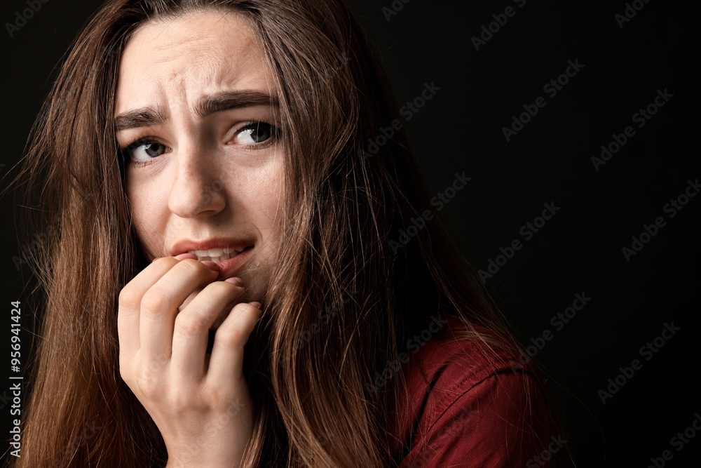 Portrait of scared woman on black background Portrait of scared woman on black background