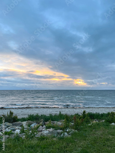 Sunset on the beach with stormy clouds on the sky