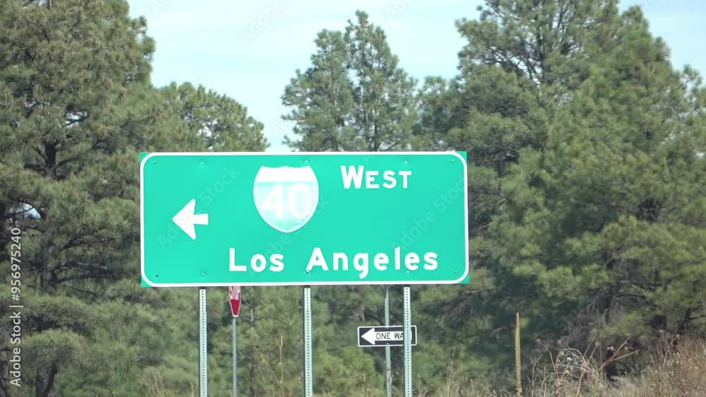 Highway directional signs to Los Angeles amidst trees in slow motion 120fps Highway directional signs to Los Angeles amidst trees in slow motion 120fps