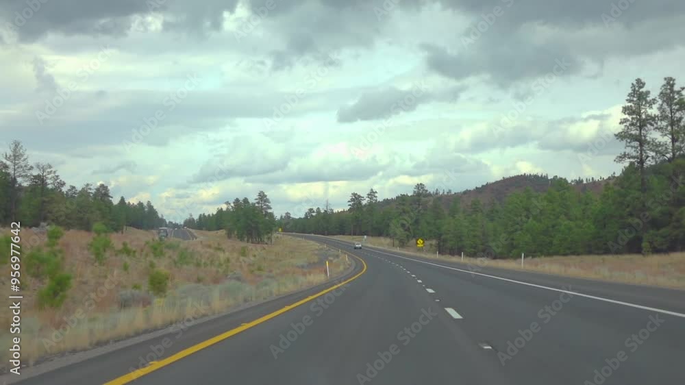Winding through a scenic highway in Arizona with surrounding forest and hills in slow motion 120fps Winding through a scenic highway in Arizona with surrounding forest and hills in slow motion 120fps