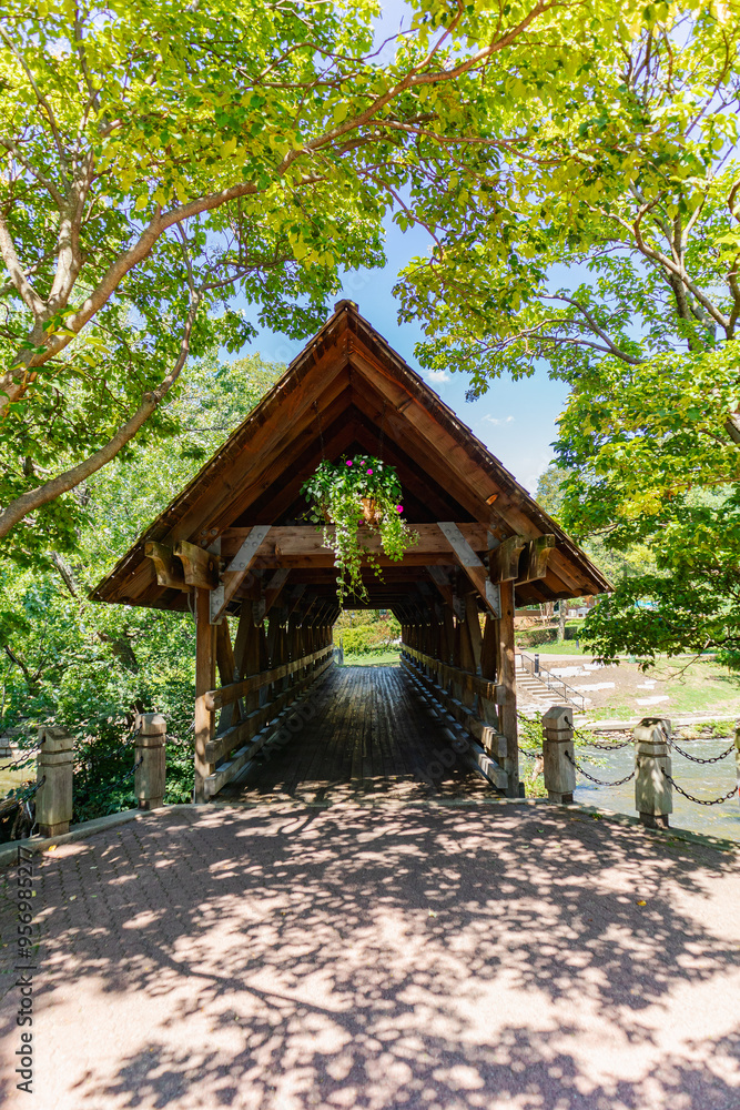 Wooden covered bridge in summer over a river Wooden covered bridge in summer over a river