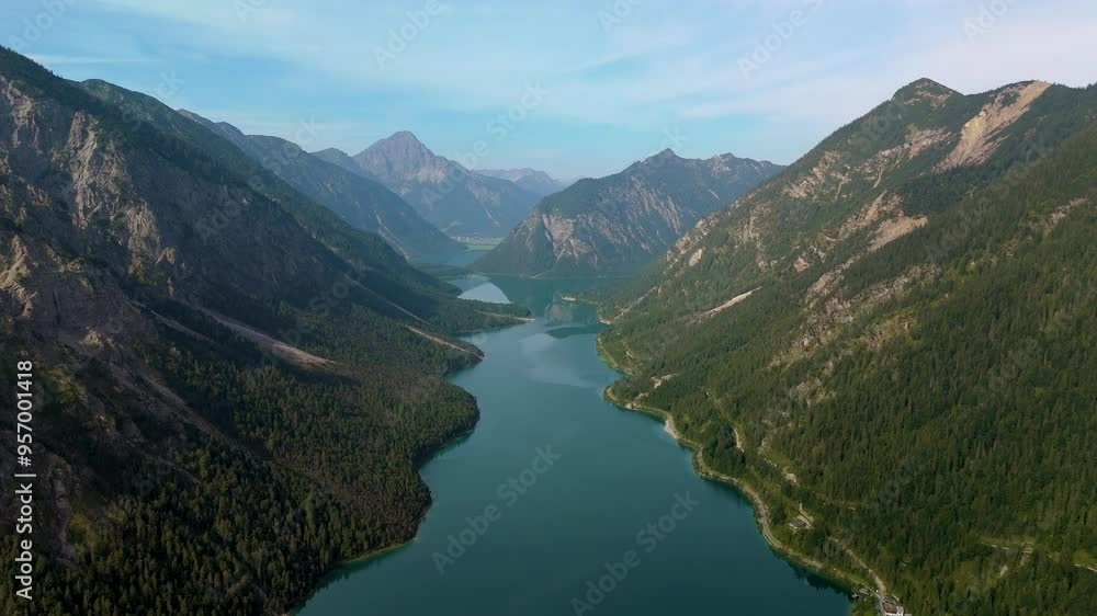 Experience the breathtaking aerial view of Lake Plansee, beautifully surrounded by majestic mountains in Tyrol, Austria Experience the breathtaking aerial view of Lake Plansee, beautifully surrounded by majestic mountains in Tyrol, Austria