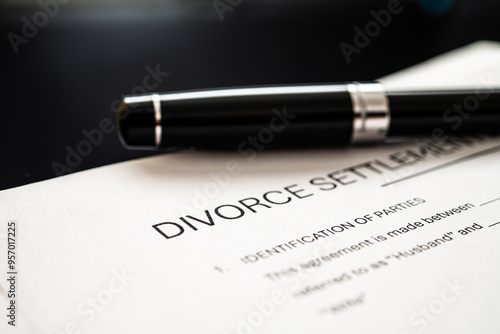 Konstfotografi Detailed divorce settlement agreement document with a sleek pen resting on top, symbolizing finalization and resolution of marital disputes in legal contexts