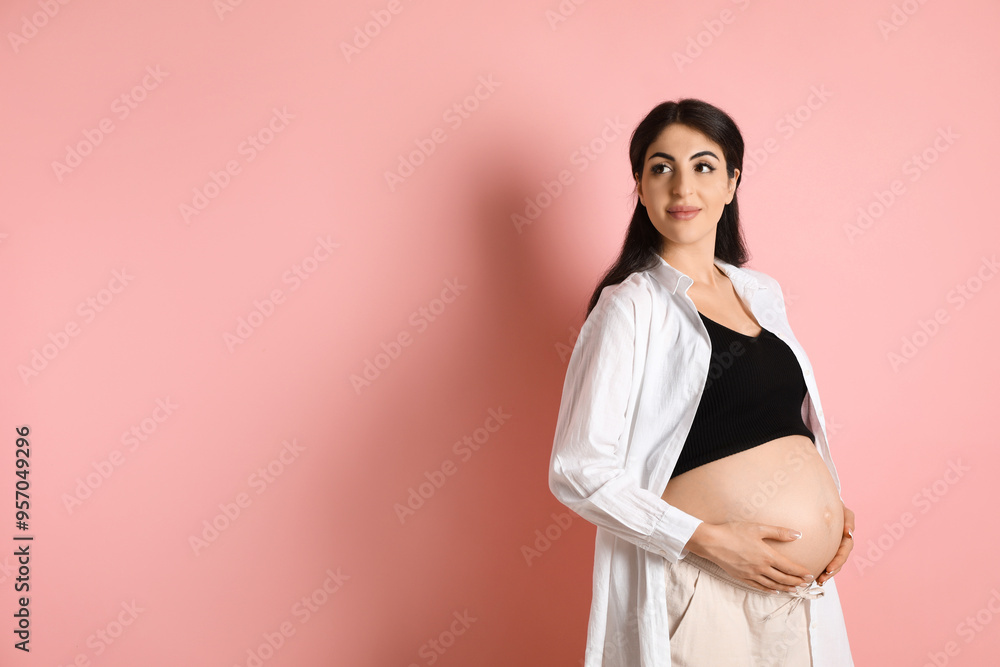 Portrait of beautiful pregnant woman on pink background, space for text Portrait of beautiful pregnant woman on pink background, space for text