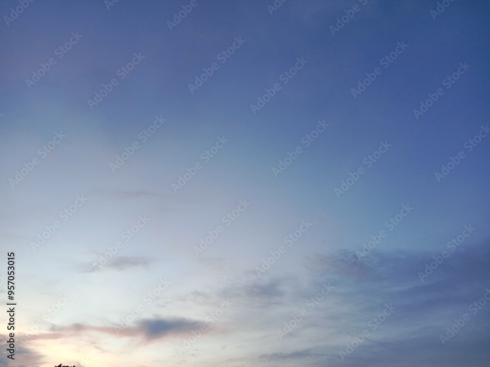 A clear blue sky with a few clouds. The sky is so clear that it almost looks like a painting A clear blue sky with a few clouds. The sky is so clear that it almost looks like a painting