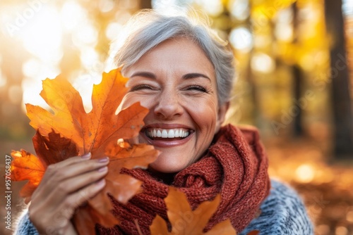 The elderly woman enjoys autumn nature with selective focus and copy space. photo