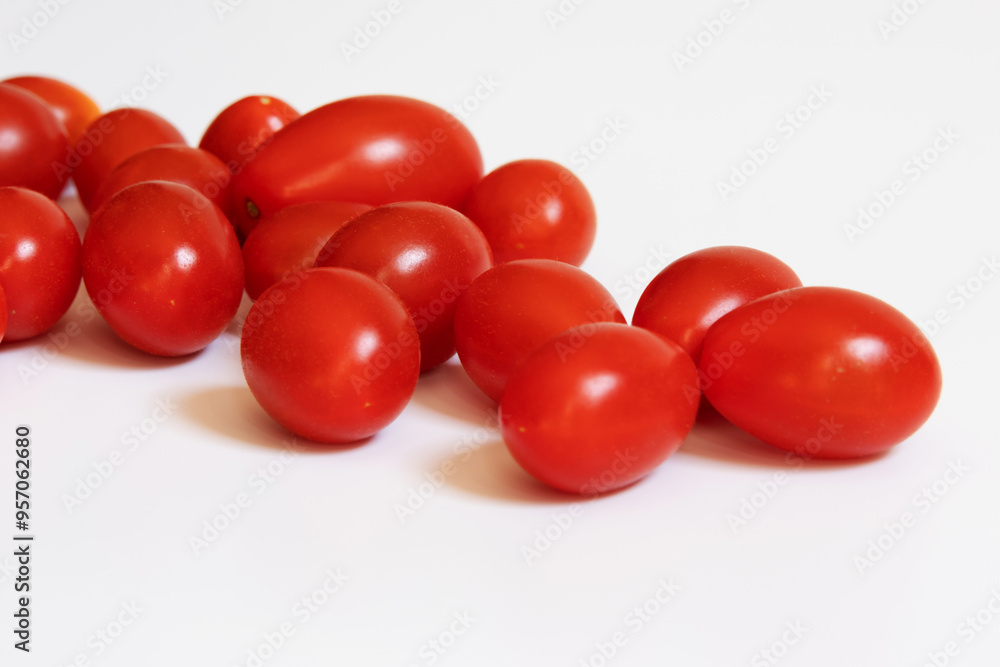 Portion of ripe cherry tomatoes photographed close up on a flat white background Portion of ripe cherry tomatoes photographed close up on a flat white background