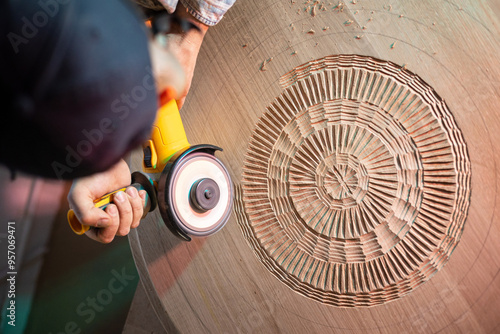 Artisan meticulously carve the hardwood to materialize his creation photo