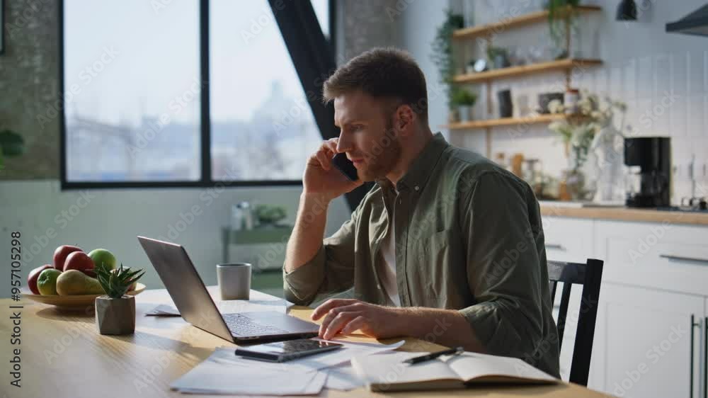 Busy freelancer answering call working laptop in home office closeup. Happy man Busy freelancer answering call working laptop in home office closeup. Happy man