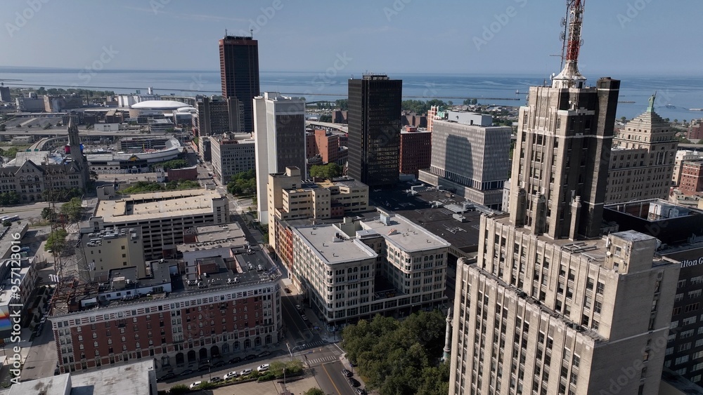 Fototapeta premium Living and working in Buffalo, New York, City skyline with office towers parks, by Lake Erie on sunny summer morning in old American City