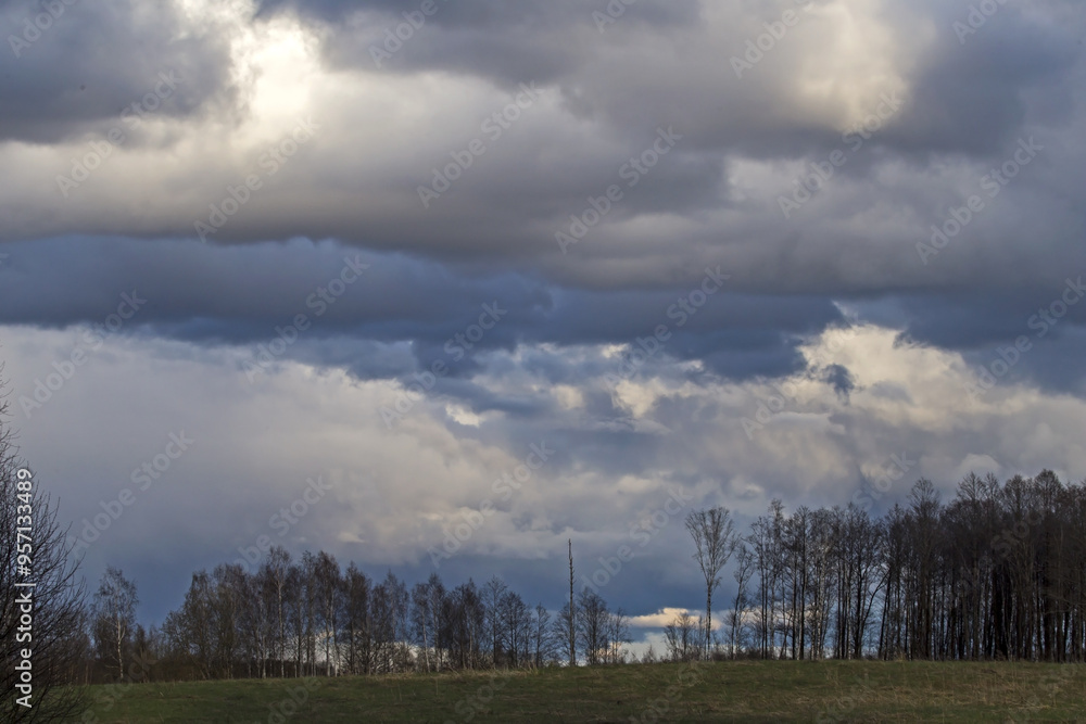 Dramatic sky over the fields. Agricultural landscape in eastern Lithuania. Dramatic sky over the fields. Agricultural landscape in eastern Lithuania.