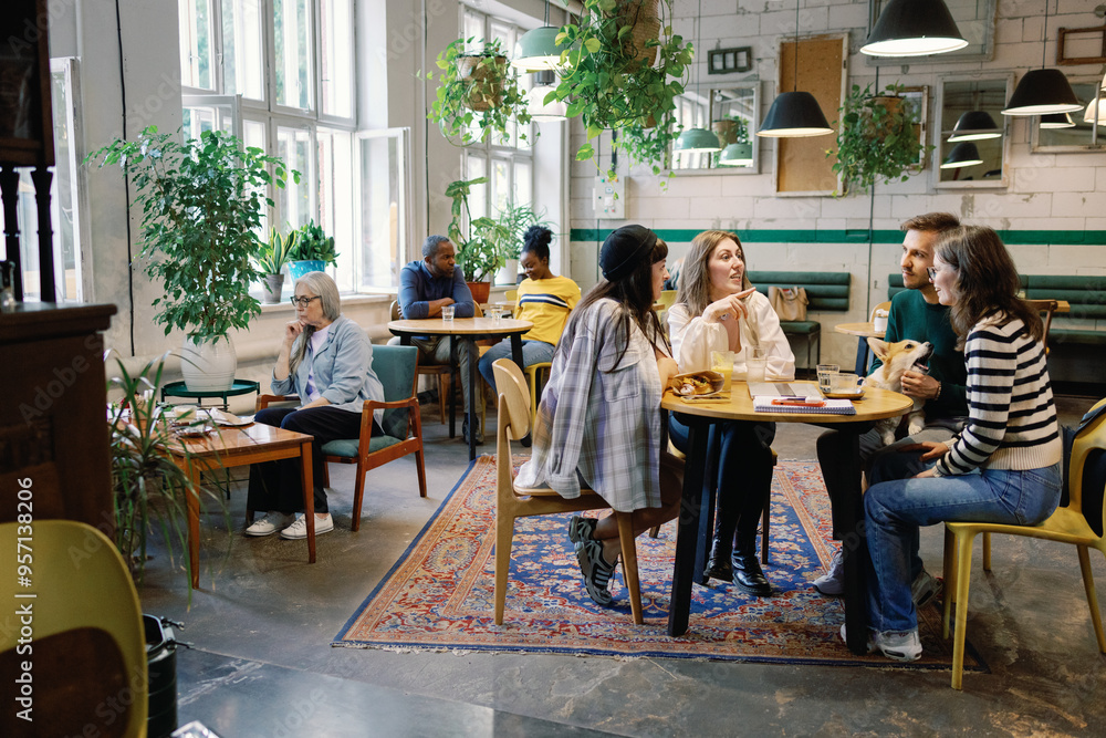 Group of multiracial people resting and enjoying time together in cafe Group of multiracial people resting and enjoying time together in cafe