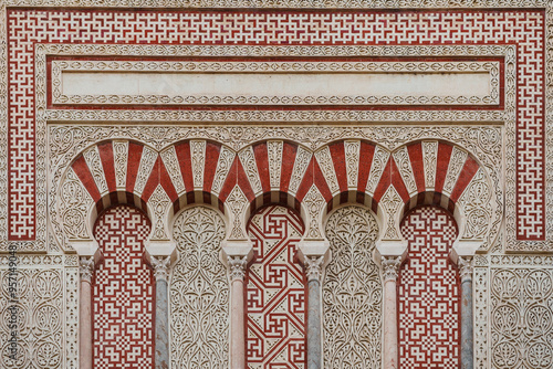 a portion of ornate Moorish architecture, with red and white patterns photo