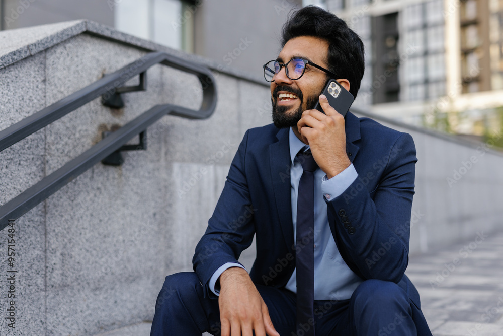 Smiling entrepreneur talking on phone during coffee break outside Smiling entrepreneur talking on phone during coffee break outside