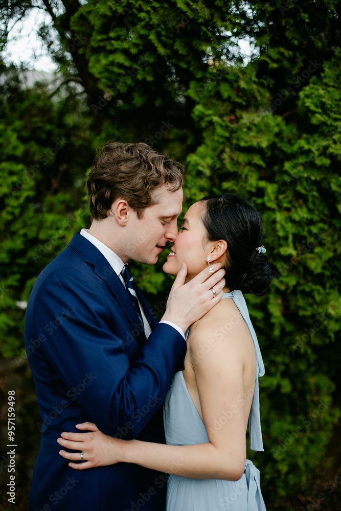 Romantic Portrait of Bride and Groom as They Lean in for a Kiss Romantic Portrait of Bride and Groom as They Lean in for a Kiss