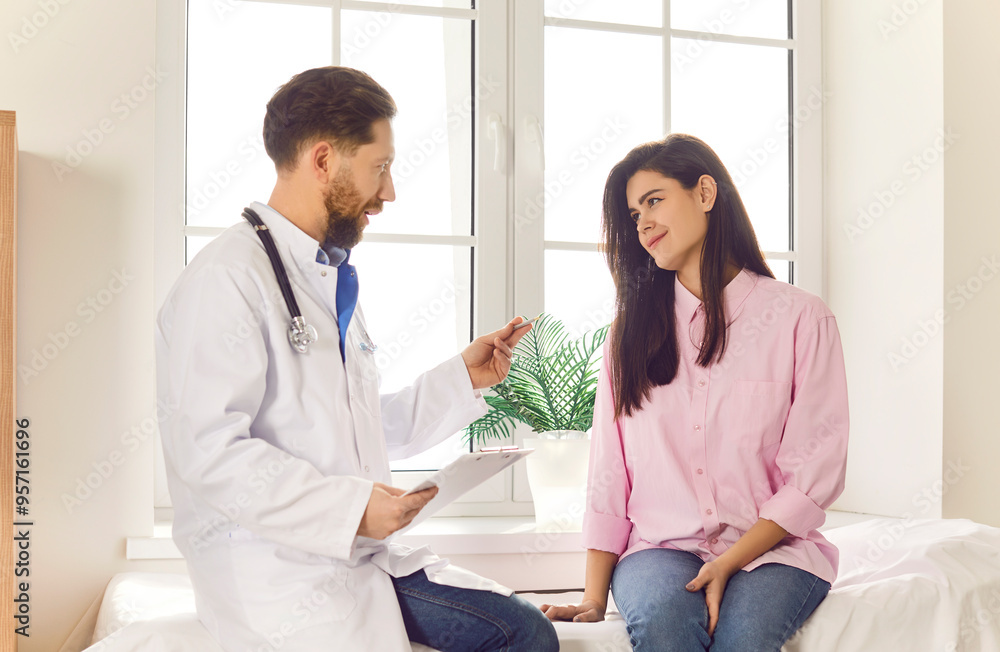 Caring male doctor provides medical care and consultation to a female patient in a hospital office. The nurse ensuring the patient receives the best medical attention during clinic medical visit. Caring male doctor provides medical care and consultation to a female patient in a hospital office. The nurse ensuring the patient receives the best medical attention during clinic medical visit.